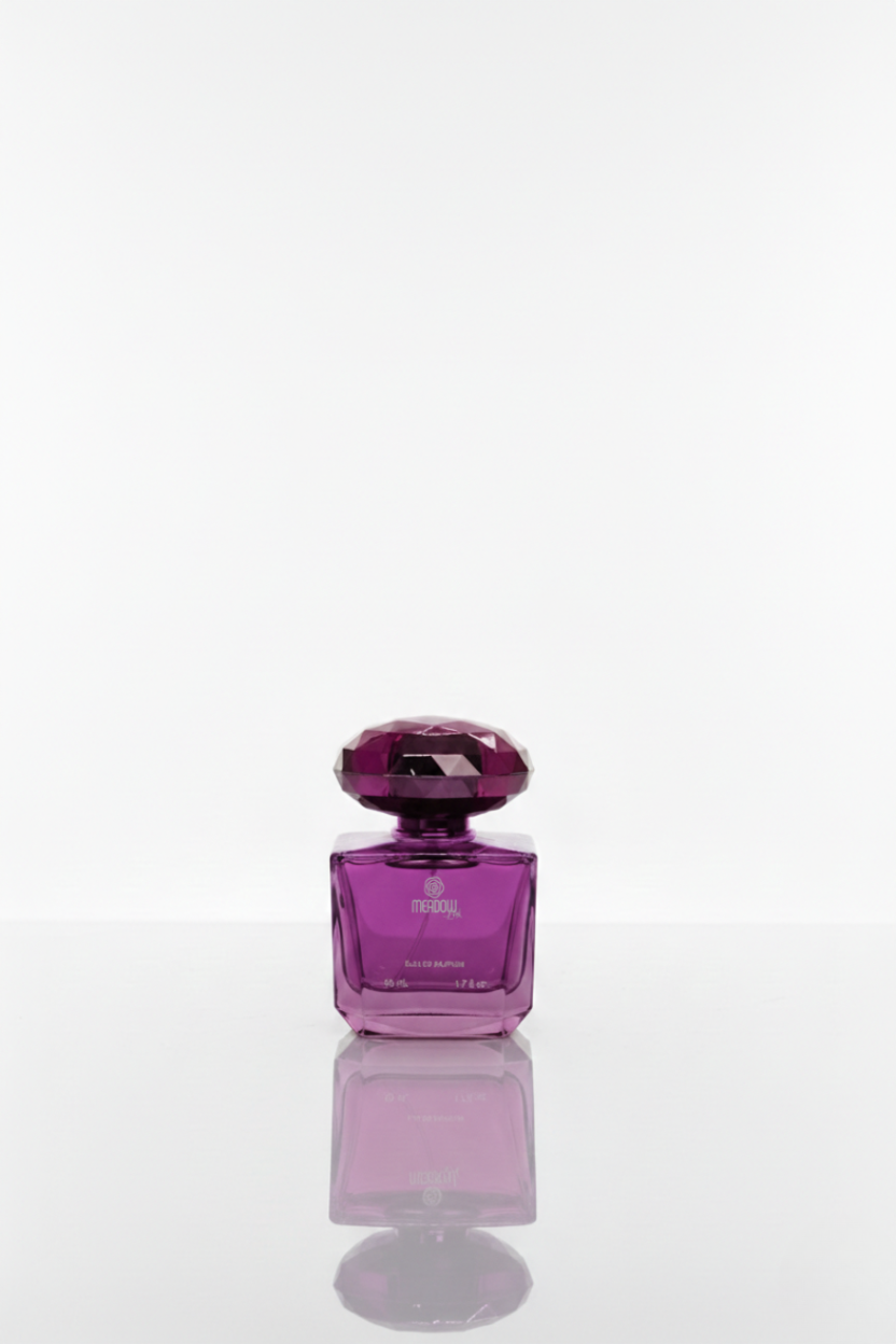 Purple perfume bottle with a reflective surface on a white background