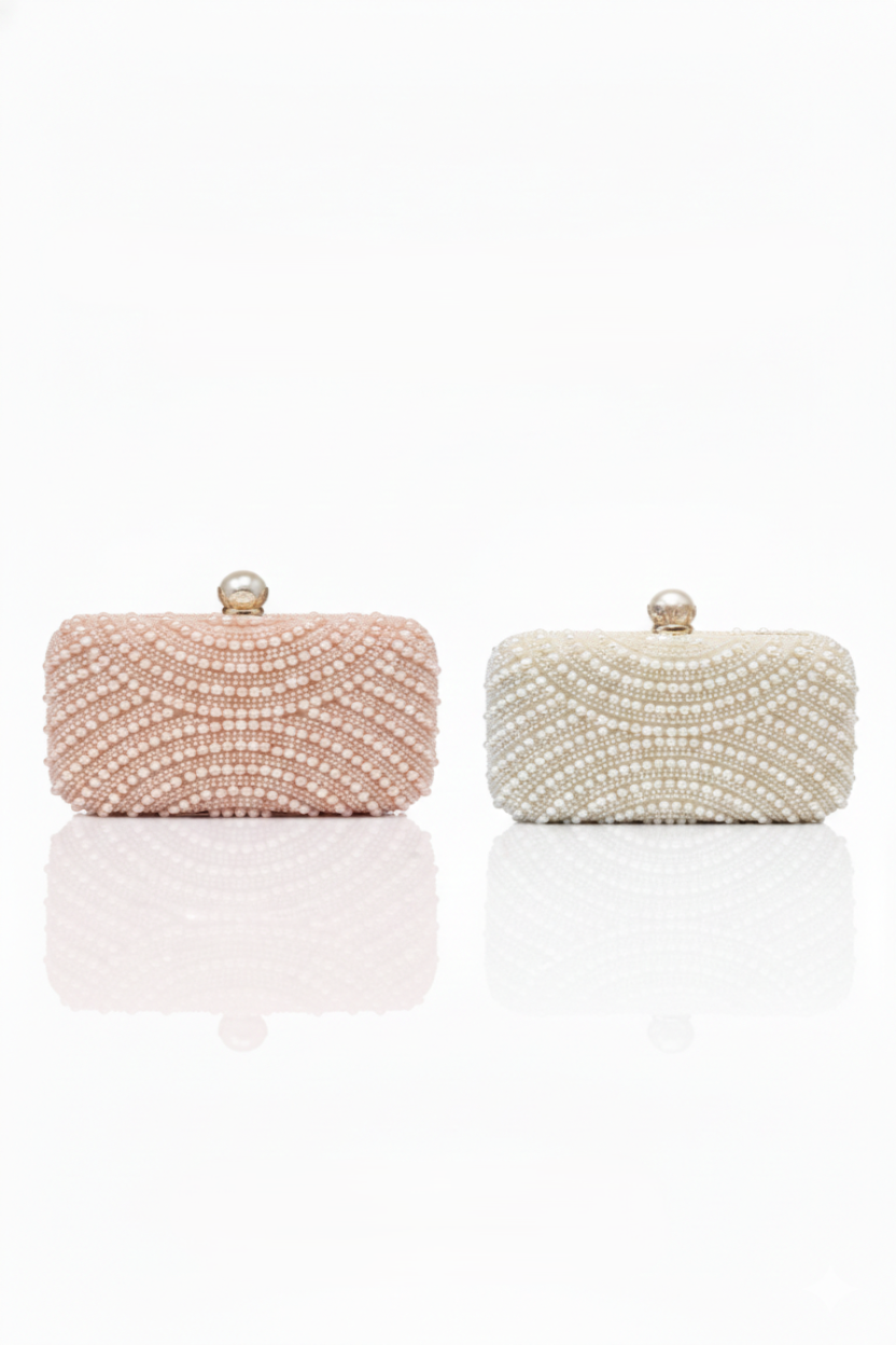 Two beaded clutch bags, one pink and one white, on a white background