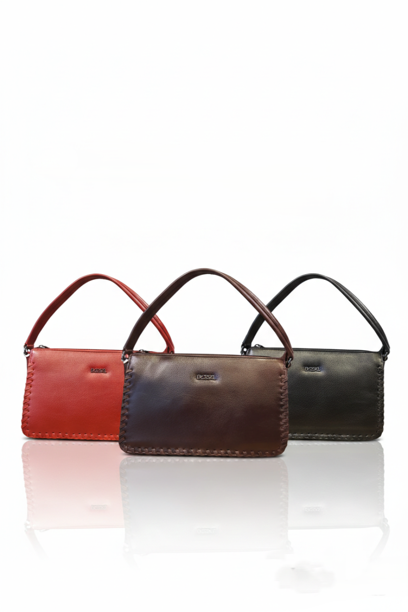 Three leather handbags in red, brown, and black on a white background
