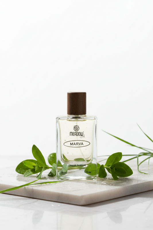 Perfume bottle labeled 'Meadow' with green leaves on a white background